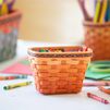 Crayola x Longaberger small crayon basket, apricot, on table with art supplies.