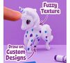 Scribble Scrubbie Pets Confetti Party Playset. fuzzy texture. draw on custom designs. finger touching unicorn pet with blue and purple decorations.