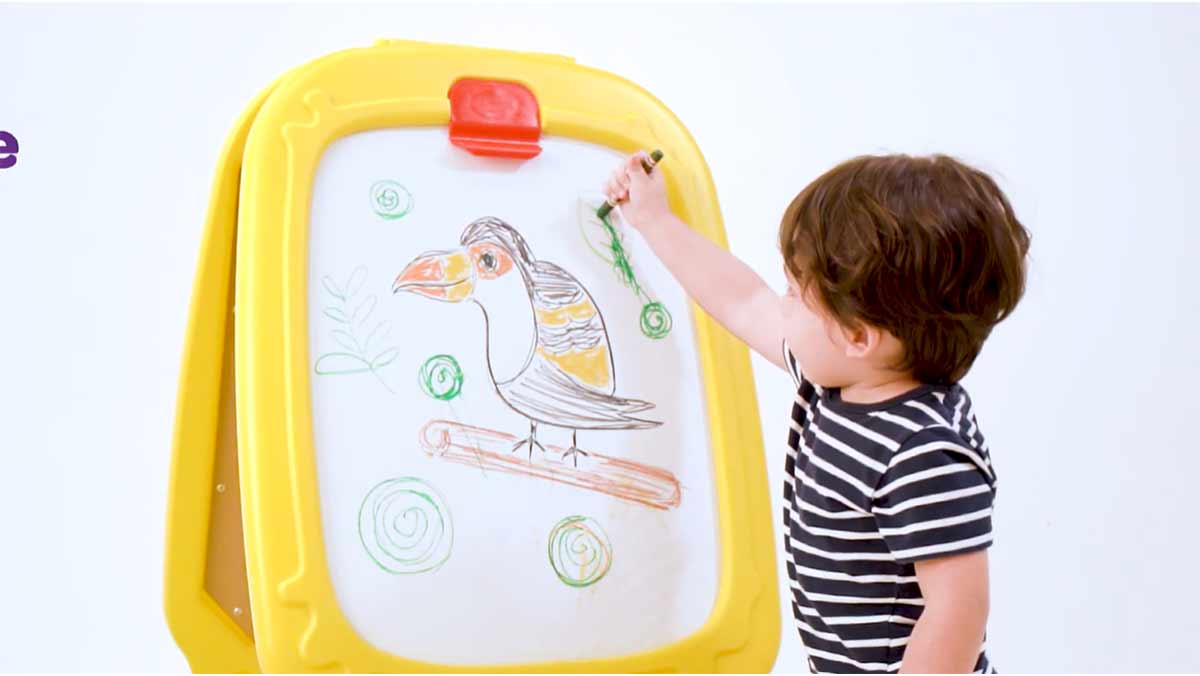 Deluxe Magnetic Double-Sided Easel. Two children drawing on each side of the Crayola Deluxe Magnetic Double-Sided Easel.